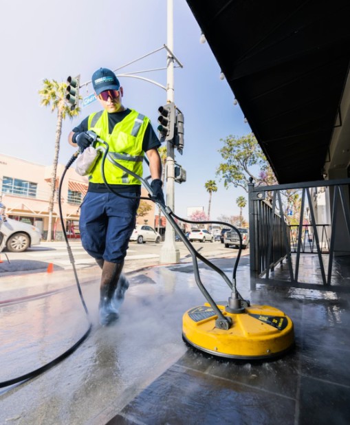 Professional high-pressure cleaning of a paved driveway